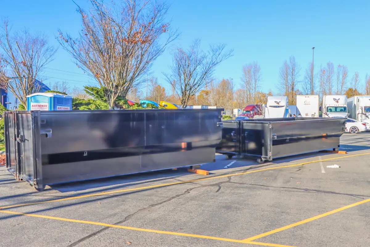 Professional dumpster rental service with roll-off container on residential driveway in Greenacres